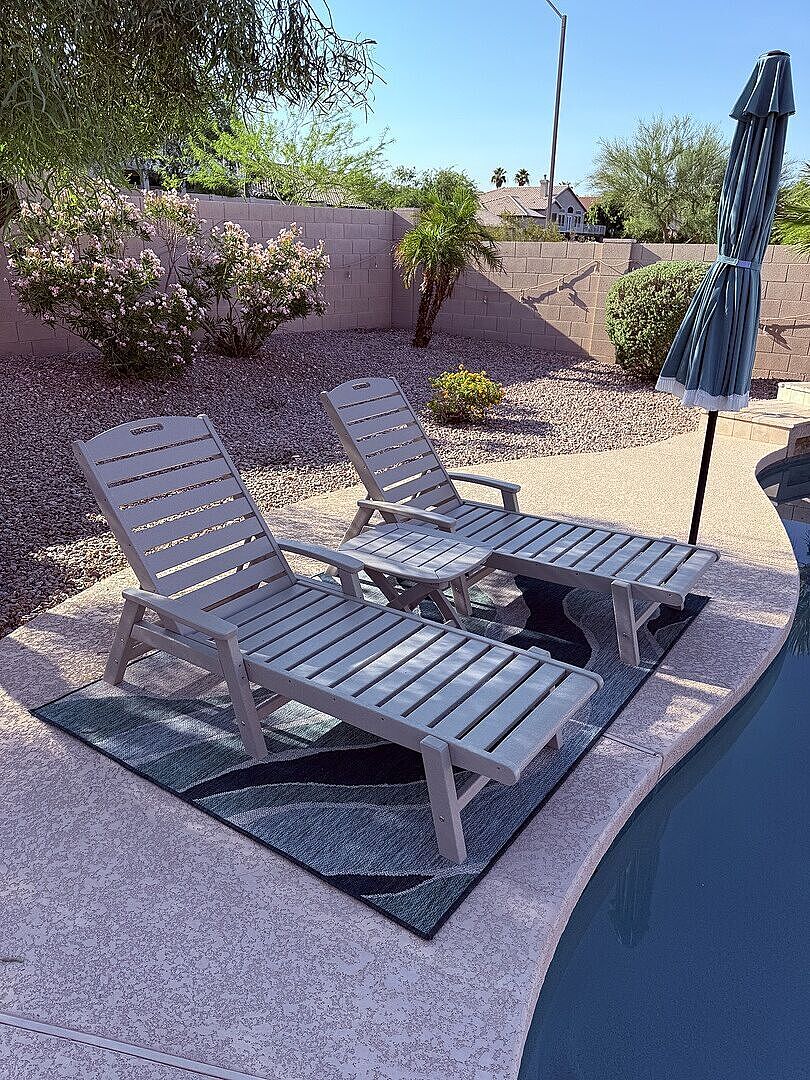 A grey POLYWOOD Yacht Club 3 Piece Chaise Set sits on a poolside patio.